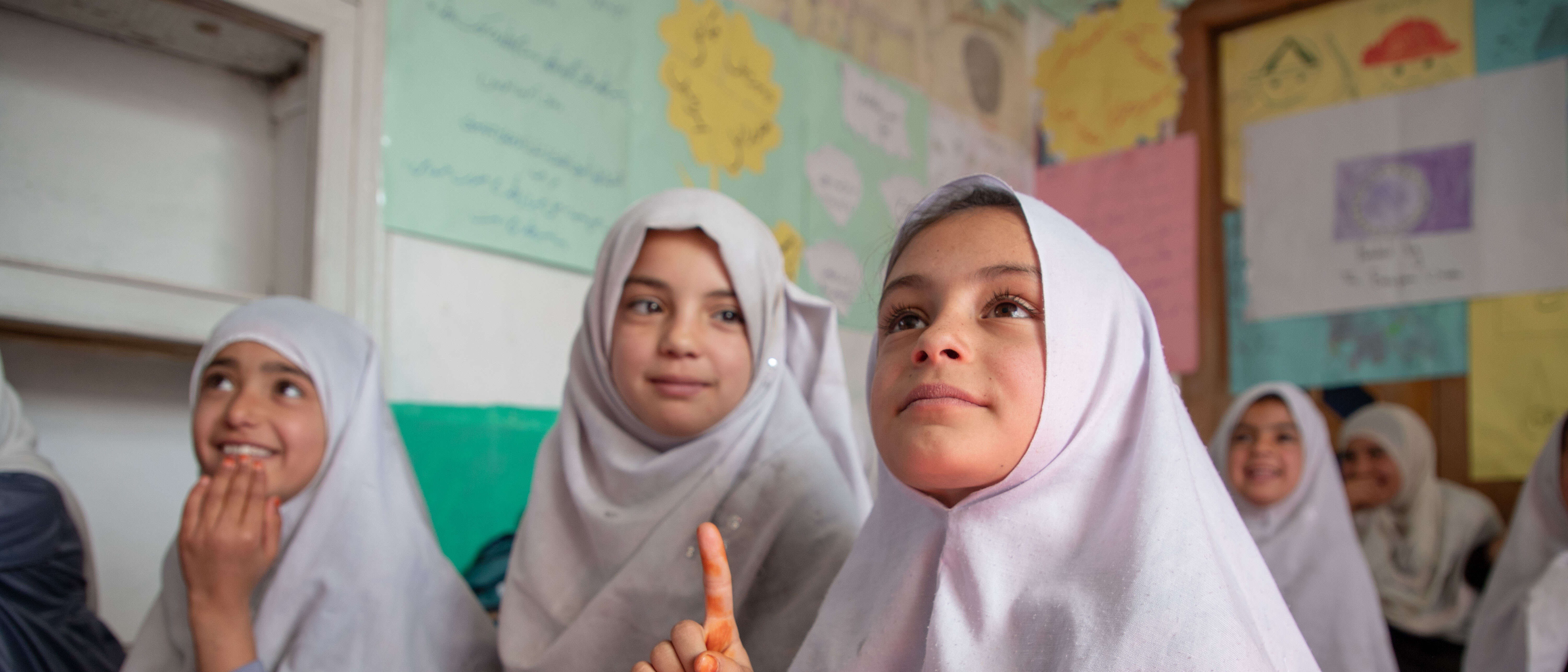 A group of girls study together in a classroom in Afghanistan.
